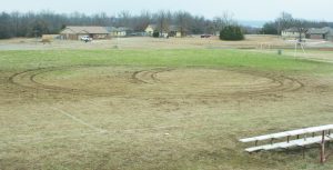 Soccer Field vandalised with donut tracks.