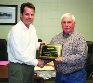 Wayne Burke accepts his honor of 30 years service from Superintendent Dr. Steve Waldvogel.