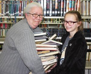 Ms. Gaebler passes the 'torch' to MMS student Isabel Bruski.