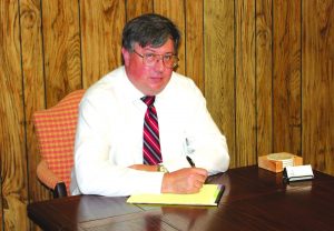Attorney John Dunn takes notes at his new law office in Mannford.          HARMON PHOTO