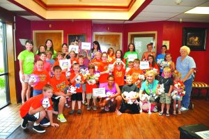 Kids for Christ posing at Cimarron Pointe Care Center in Mannford after spending some time with its residents.