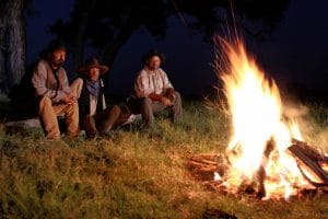 The bank robbers preparing to split the loot under the cover of night.